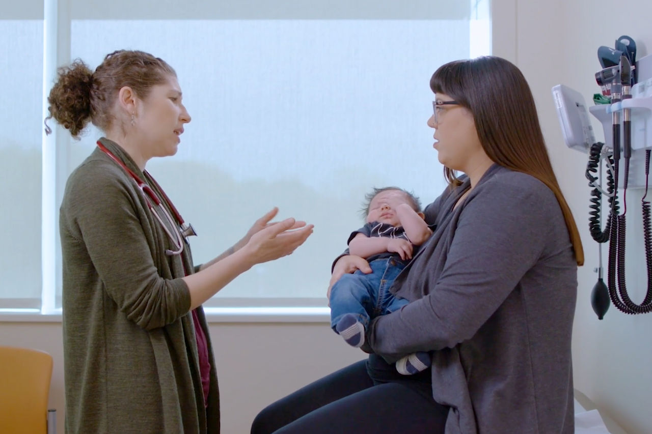 Doctor speaking with mother and child