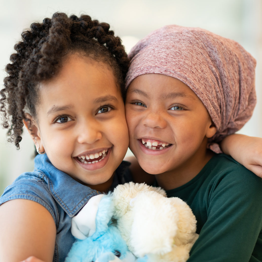 Two smiling girls and hugging