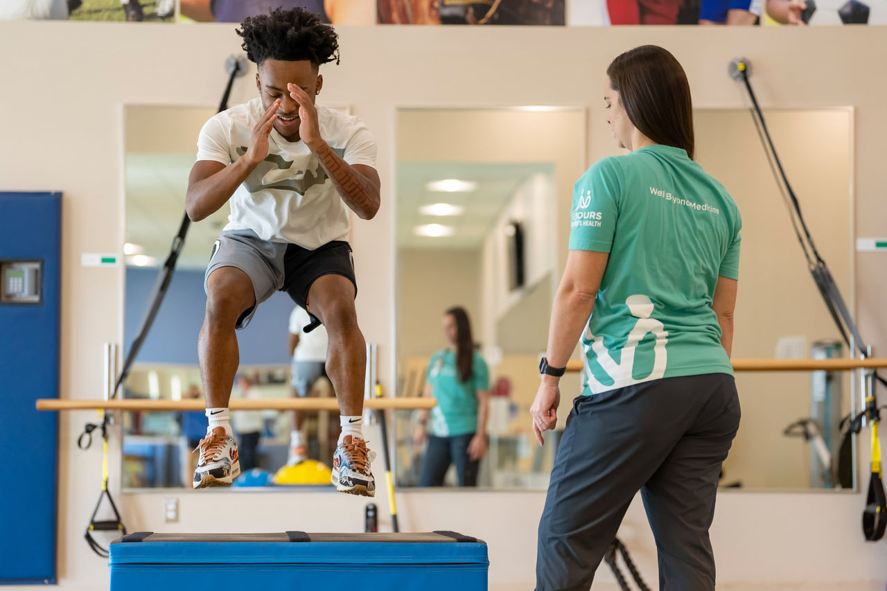 Teen boy athlete jumping in physical therapy