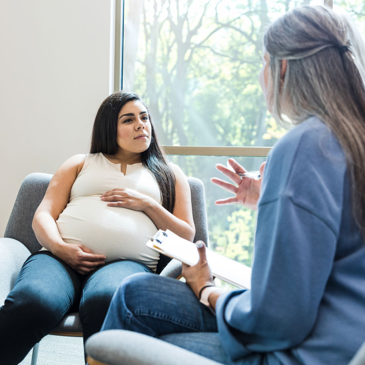 Pregnant Woman in Counseling Session with Advisor