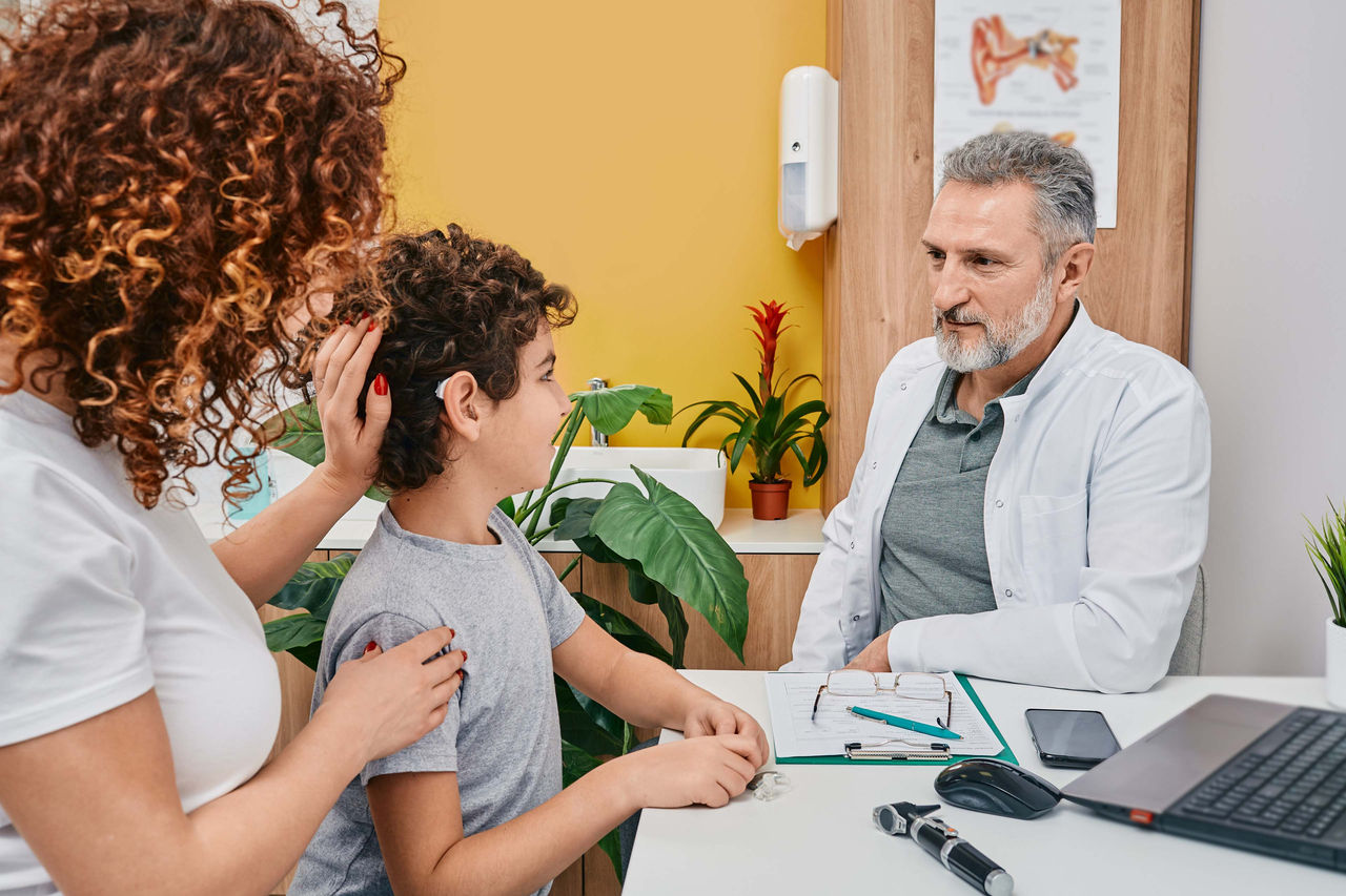 Doctor sitting with patient and mom
