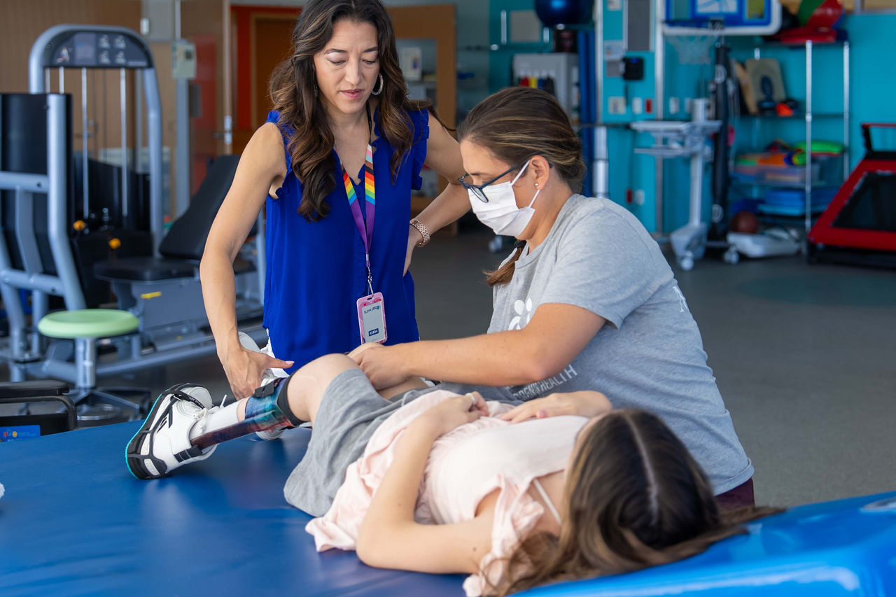 Therapists working with patient with leg braces
