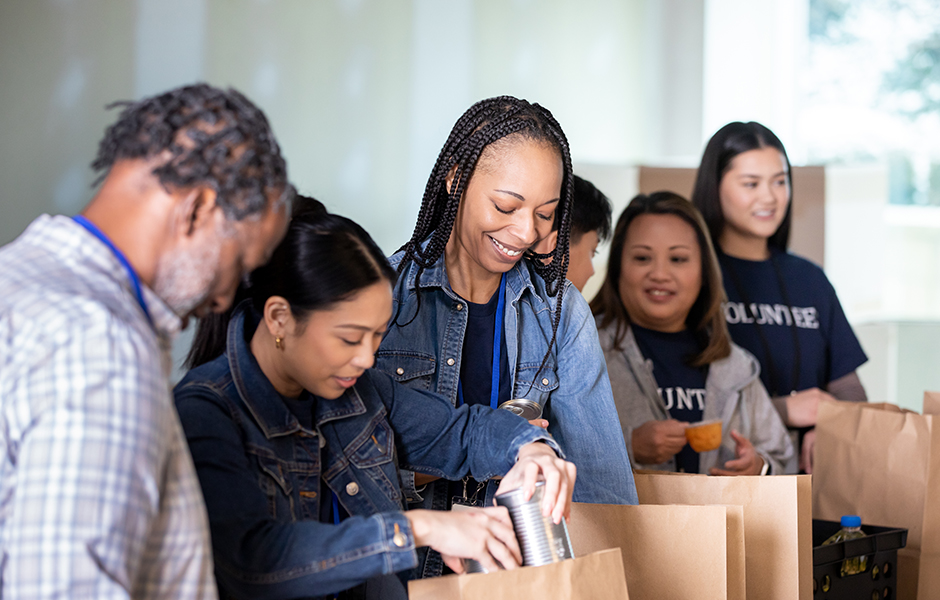 A group of community volunteers bagging food.